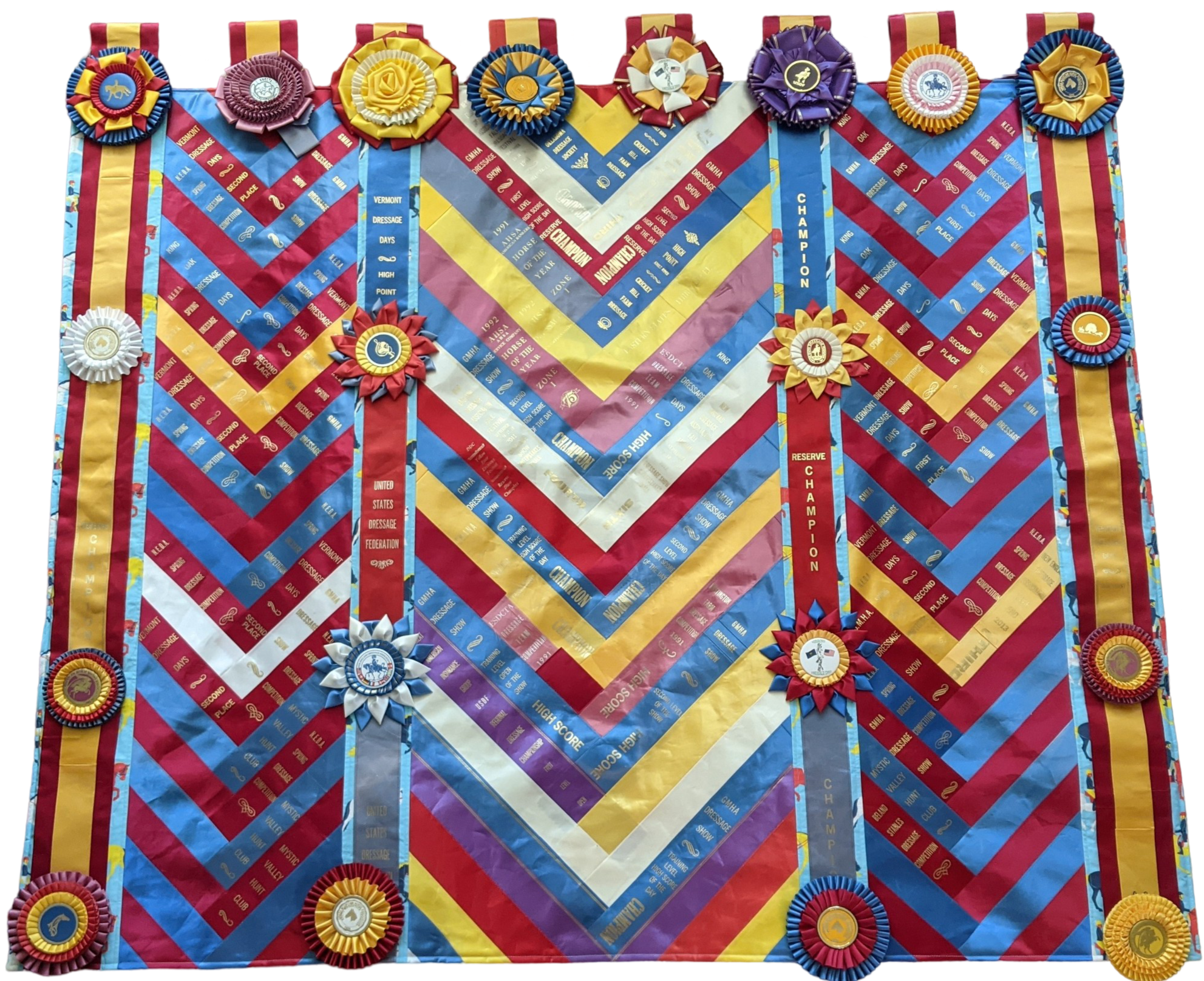 Wall hanging with three columns of ribbons laid out in a chevron pattern. Rosettes are stitched across the top where loops are attached for display and at quarterly intervals down the columns.