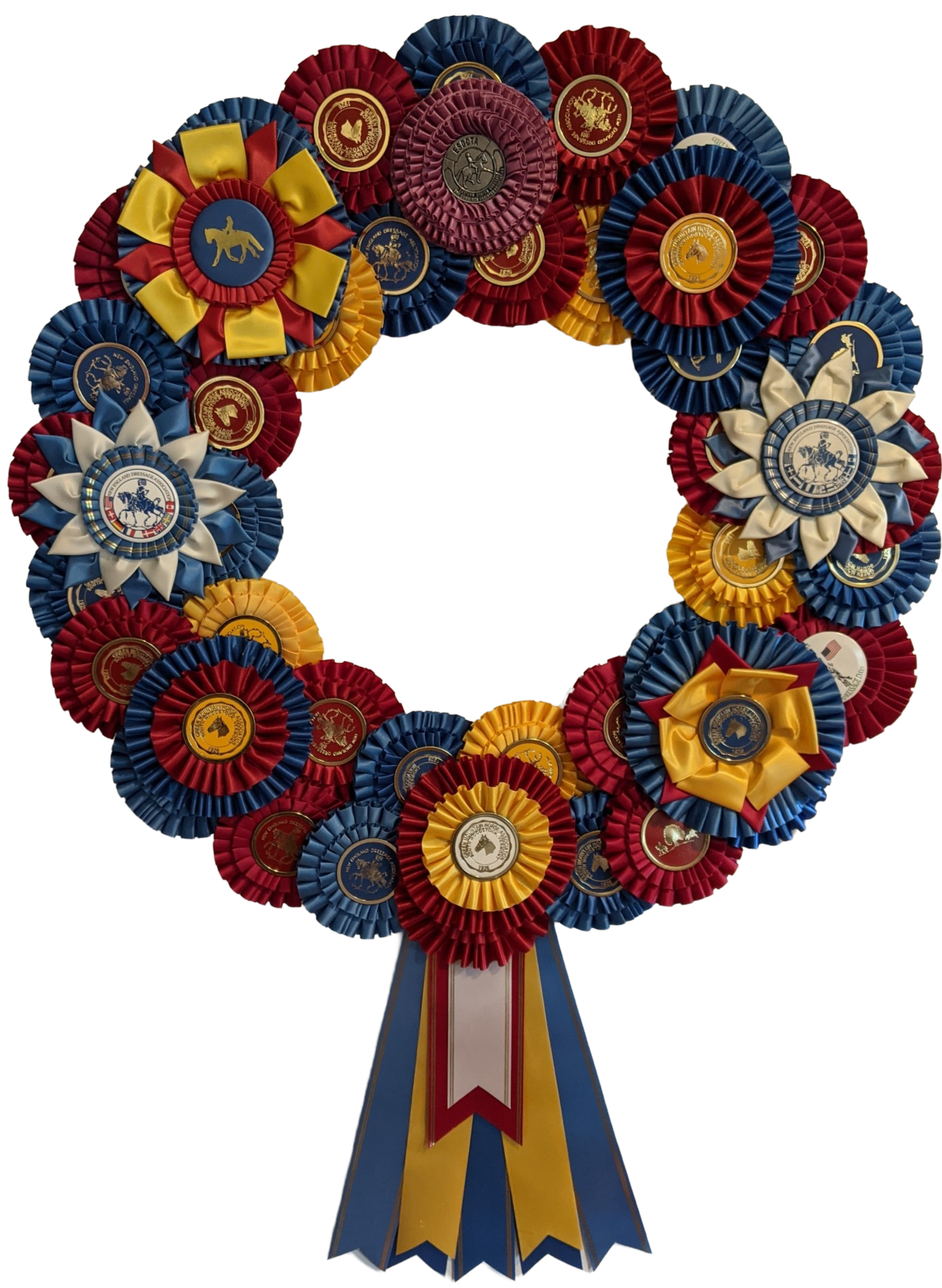 Wreath made from overlapping rosette ribbons with layered ribbon tails hanging from the bottom.